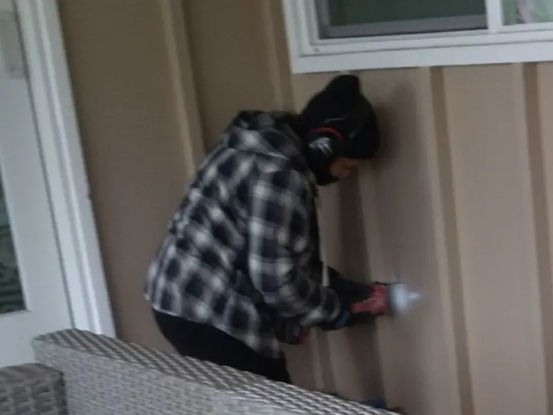 Professional electrician installing an exterior outlet in Armona