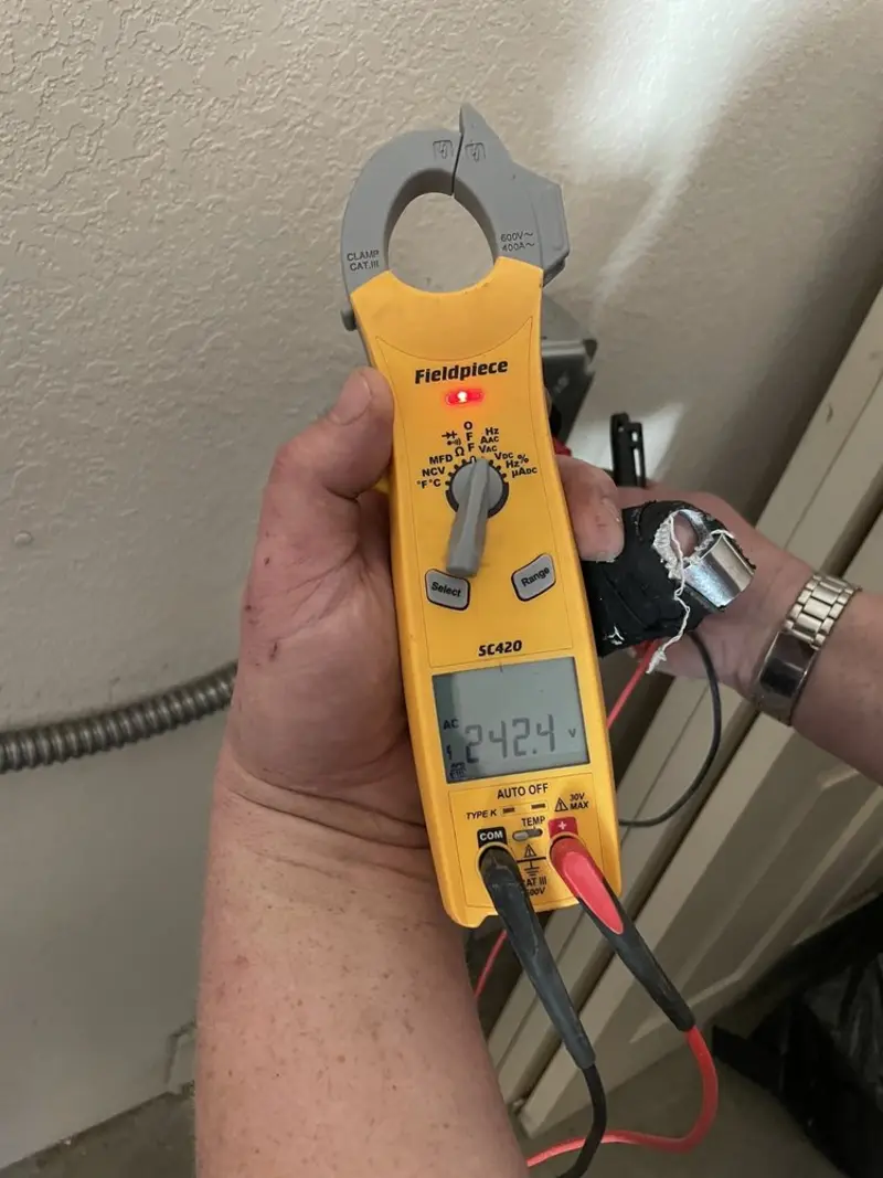 Voltage testing with clamp meter during Ceiling Fan Installation in Armona